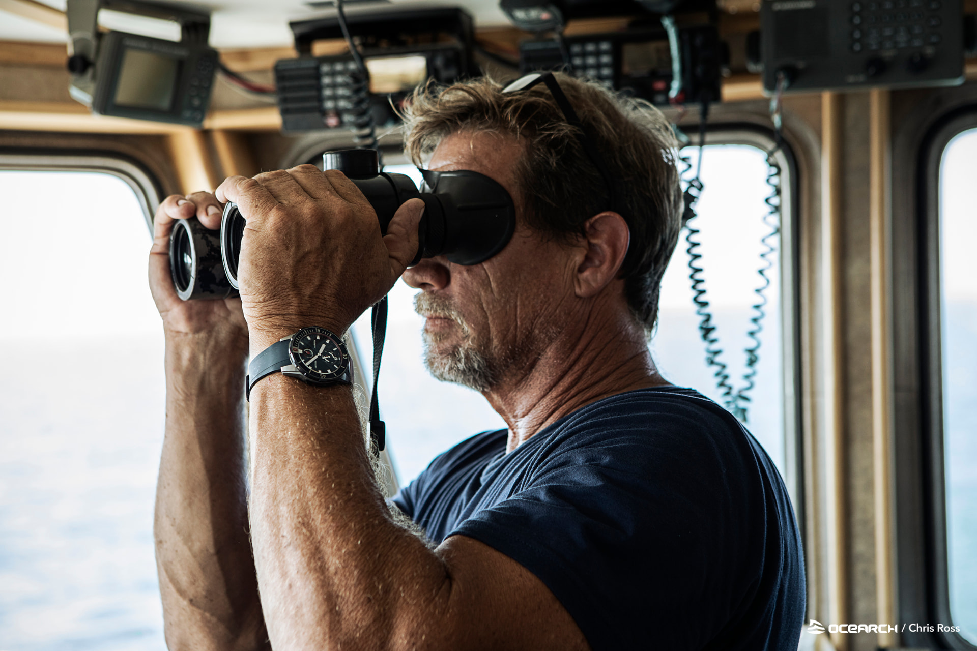 OCEARCH Captain Brett McBride scanning the horizon from the research vessel bridge